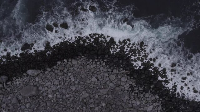 Waves crash onto the beach of Senja Island in Norway View from above, D-Log for better color grading