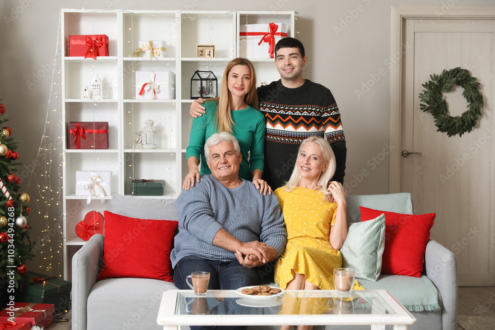 Wall mural Young couple with their parents at home on Christmas eve