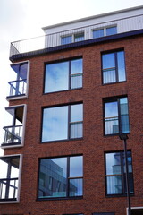 Modern red brick building with large reflective windows and minimalistic design. Noblessner, Tallinn, Tallinn, Estonia. August 2024