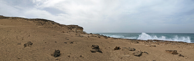Panoramic view of the wild rocky west coast of Fuerteventura, Canary Islands, in cloudy weather and crashing waves