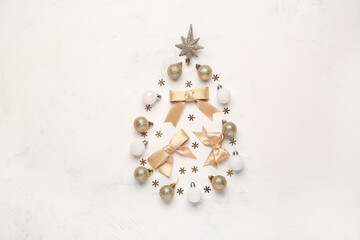 Christmas tree made of stylish decorations on light background