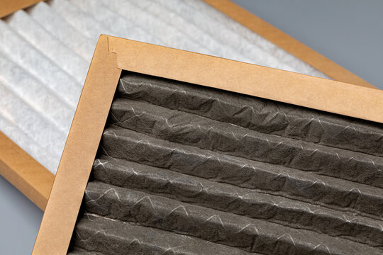 Dirty and new furnace filter comparison. HVAC maintenance, indoor pollen allergy and duct cleaning concept.