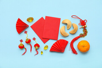 Red envelopes with fortune cookies and Chinese symbols on blue background. New Year celebration