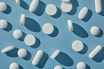 white pills on blue background