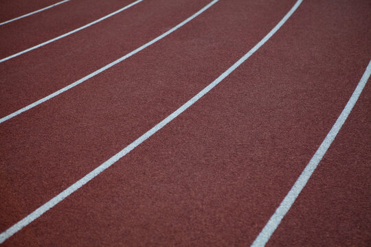 Red rubber track and field lines, lanes background texture