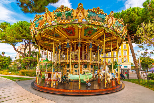 The colorful carousel at Albert I Garden, or Jardin Albert 1er near the Promenade des Anglais and coast of the Mediterannean city of Nice France on the French Riviera.
