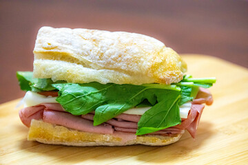 Italian mortadella bologna sandwich with arugula, tomato and cheese on ciabatta bread © Adilson