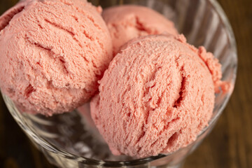 red strawberry-flavored ice cream in a glass bowl