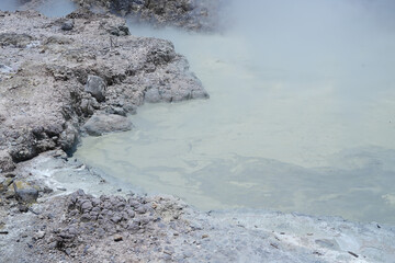 The Sikidang crater in Dieng features a greenish, acidic pool