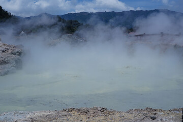 The Sikidang crater in Dieng features a greenish, acidic pool