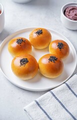 Red bean paste buns with black sesame seeds sprinkles