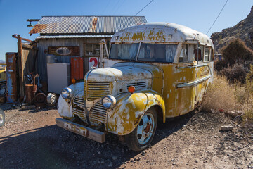 Abandoned vintage rusted vehicle in a desert junkyard
