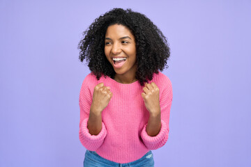 Happy euphoric Afro American female model celebrating money win with yes gesture. Excited young...
