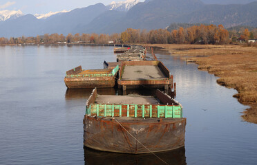 Barges moored on peaceful mountain river