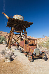 Abandoned vintage rusted vehicle in a desert junkyard
