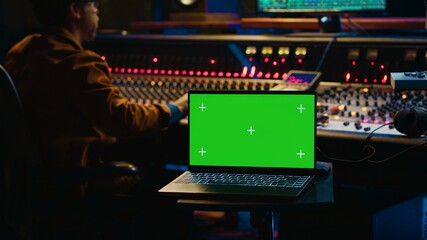 African american artist working with mockup on display in control room, mixing and mastering tracks...