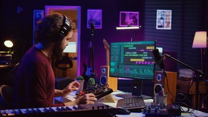 Audio engineer creating sound effects for a new soundtrack, recording tunes on electronic piano and adding creativity to audio project. Songwriter producer editing and mixing recordings. Camera B.