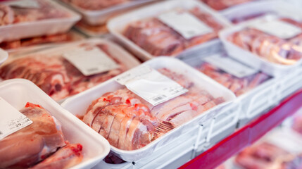 Packaged mutton meat displayed on shelves of animal products section of supermarket