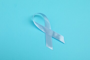 Prostate cancer awareness. Light blue ribbon on color background, space for text