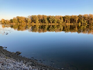 autumn trees reflected in water