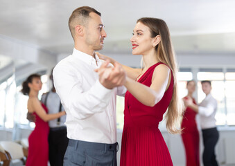 During rehearsal of reporting concert, young man and girl participants of dance workshop perform figure waltz. Group training and rehearsal, preparation for competitions