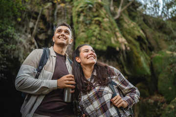 hiker couple backpackers explore forest and have fun together