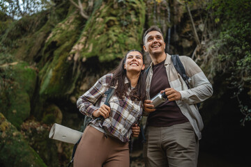 hiker couple backpackers explore forest and have fun together