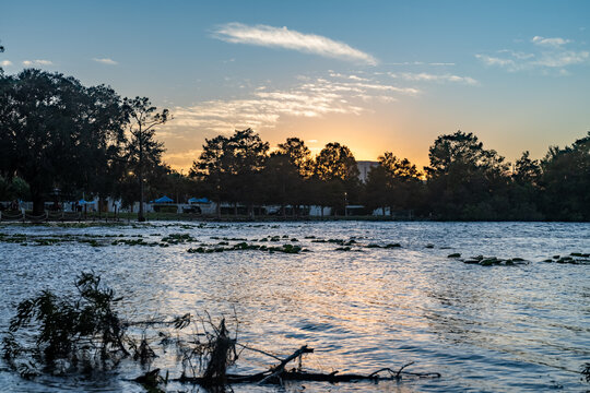 Sunset views over Byron Lake create a mesmerizing scene, with the golden light reflecting off the calm waters. The silhouette of trees and the soft colors in the sky bring out the peaceful, serene bea