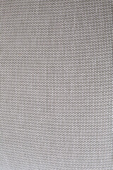 Green and white upholstery fabric textile. Thin striped woven pattern. Close-up detail photograph.