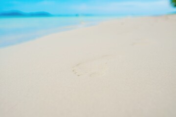 Empty beach, footprints on sand