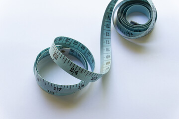 Blue measuring tape with various layouts isolated on white background.