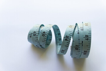 Blue measuring tape with various layouts isolated on white background.