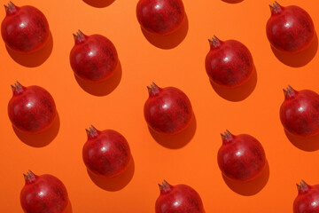 Fresh juicy pomegranate on an orange background