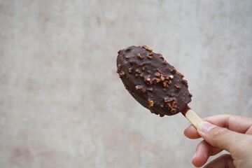 Holding Ice cream chocolate isolated on abstract background.