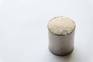 Indonesian Kalimantan native raw rice in a can isolated on a white background.