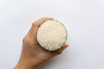 Asian man holding Indonesian native Kalimantan Indonesian raw rice in cans isolated on white background.