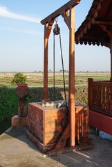 photo of a simple well in the shape of a box that looks old and classic