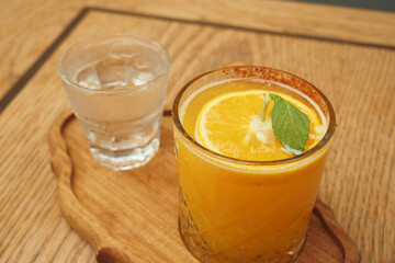 Enjoy a Refreshing Citrus Drink with Mint, Served Alongside a Cool Glass of Water