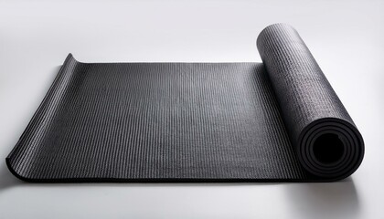 A half rolled black color yoga mat on a white surface or ground; yoga exercise black color mat on the floor; product photography