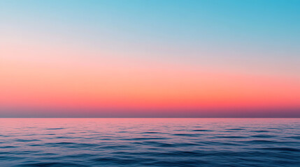 Fototapeta premium Serene ocean view during sunset, showcasing calm waves and a gradient sky with hues of blue, pink, and orange--perfect for relaxation and tranquility.
