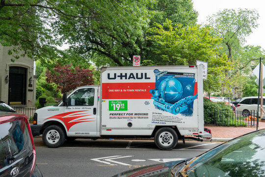 Washington, DC US - June 23 2021: U-Haul rental box truck with colorful logo and marketing materials painted on the side, parallel parked on the street