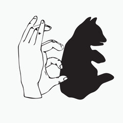 Hand shadow made into the shape of a cat pupppy, black and white, white background.