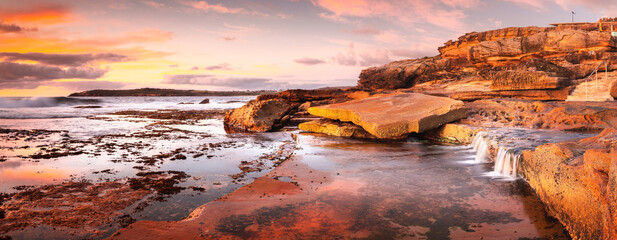 Sunrise across the ocean and broken  rockshelf © Leah-Anne Thompson