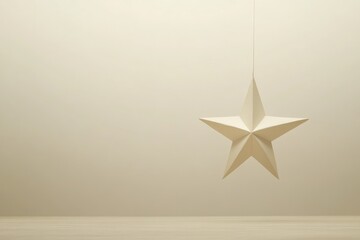Fototapeta premium A White Paper Star Hanging from a String Against a Light Beige Background