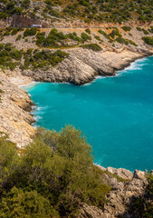 Obraz premium Small and savage beach on a rocky coast of the sea.