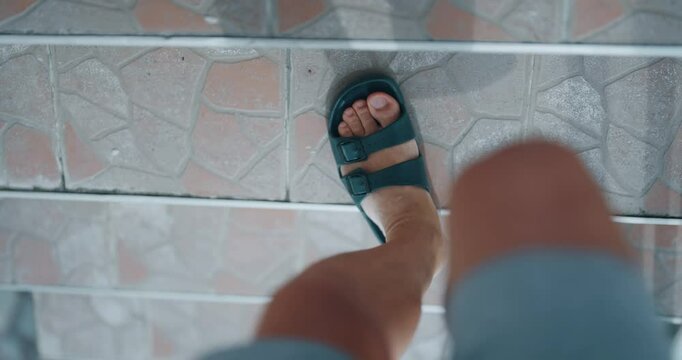 Man descending stairs in slippers, first-person perspective pov