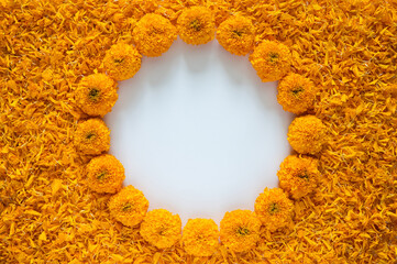Decorative orange color marigold flowers and petals rangoli for Diwali festival with white space background.
