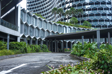 Sustainable glass office building with green trees for reducing heat and carbon dioxide. Office building with green environment.