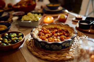 Pumpkin pie on Thanksgiving dining table.