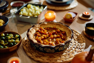 Traditional Thanksgiving pumpkin pie on dining table.